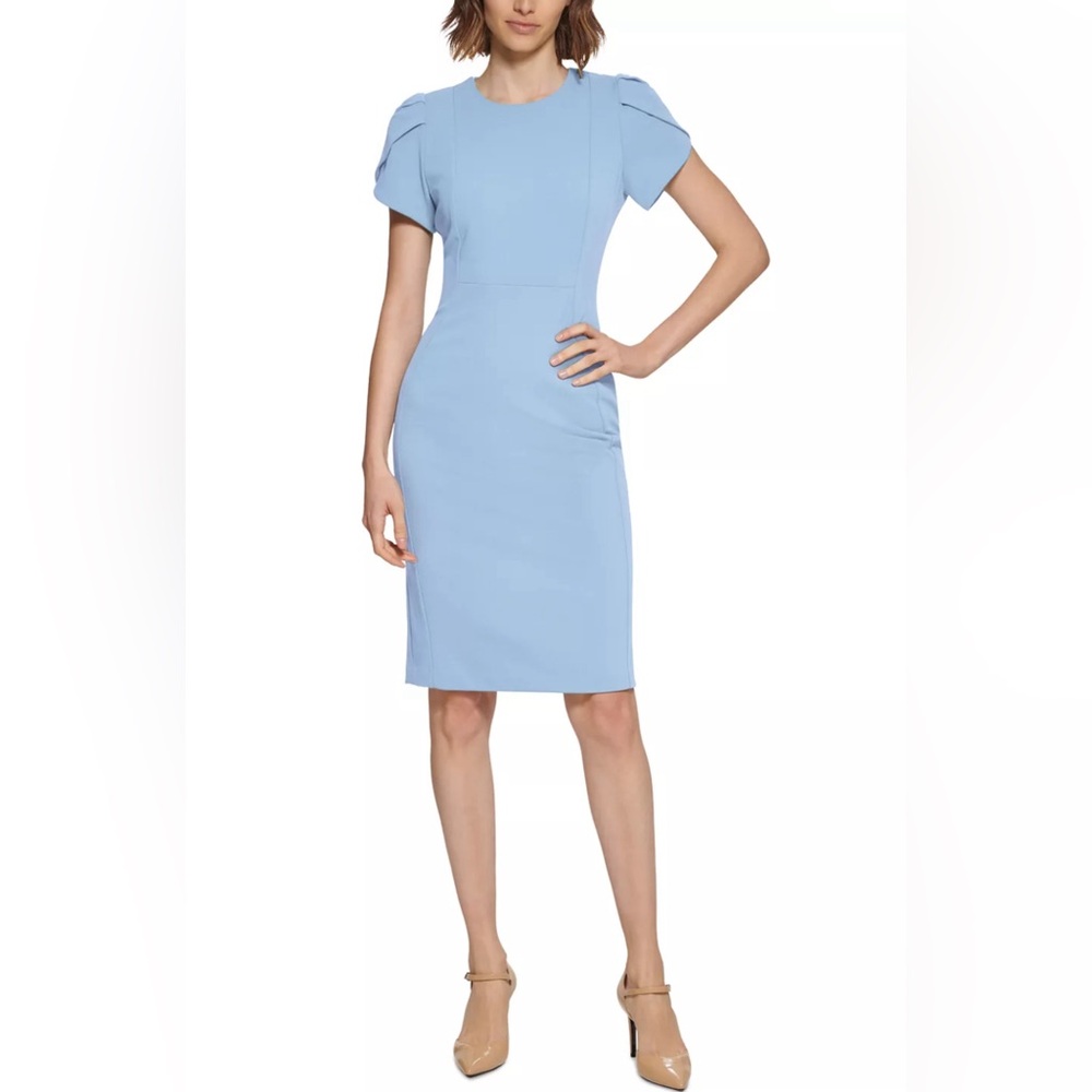 Never worn light blue Calvin Klein dress. Knee length with puff sleeves.